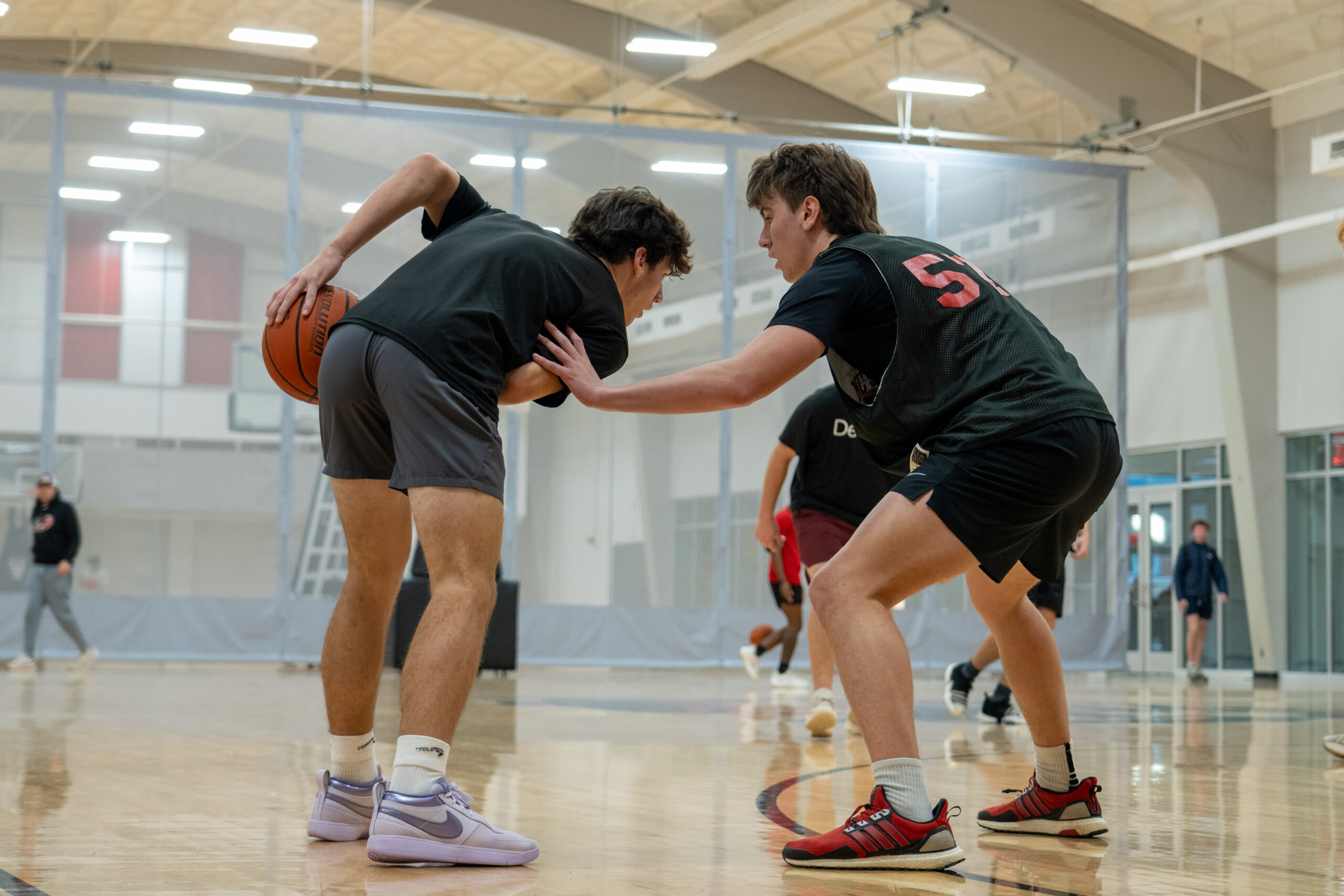 A basketball player defends another basketball player at the gym, similar to how our immune system protects our health.